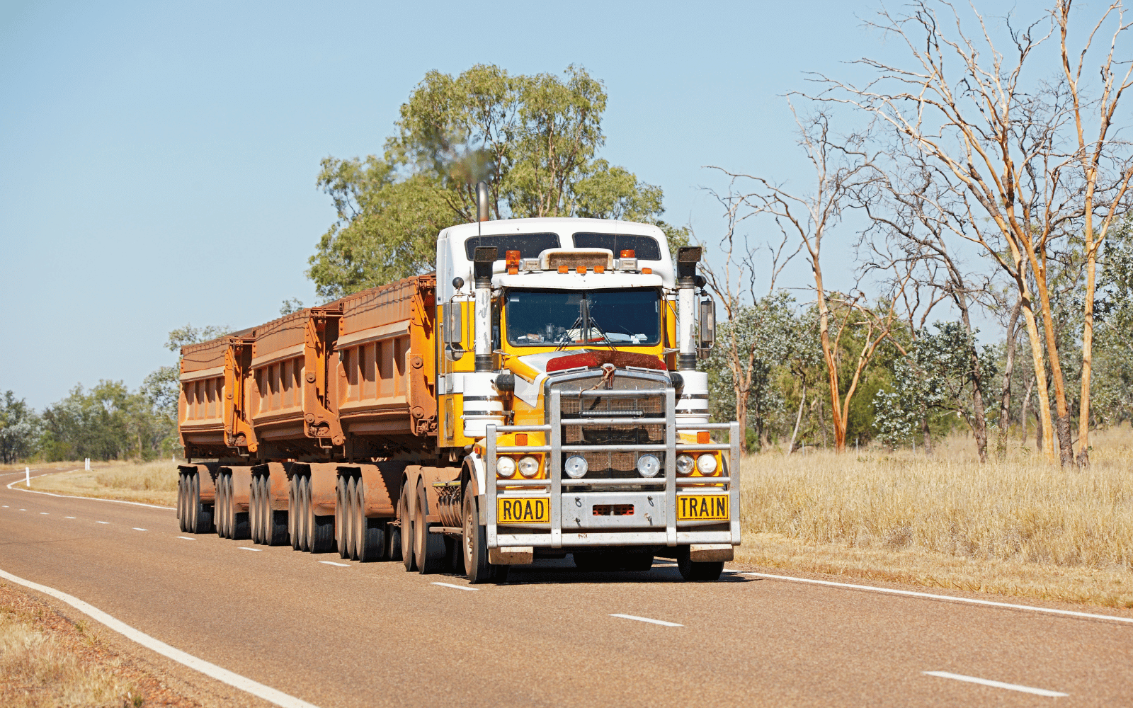 A road train hauling freight on a rural Australian highway